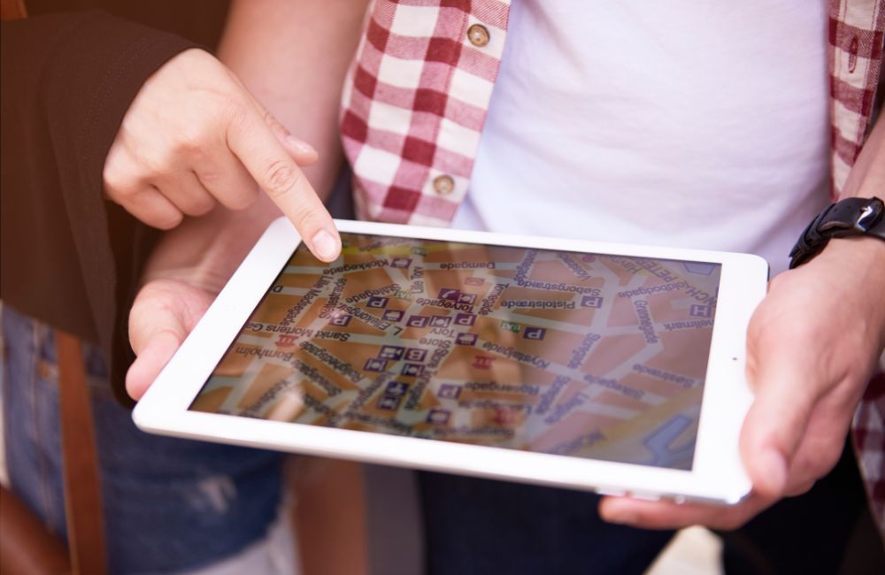 Finger zeigt auf ein iPad mit Karte